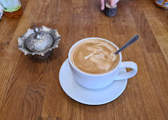 A flat white on a wooden table