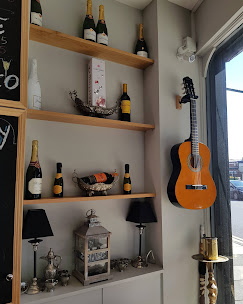 Shelves with bottles, lanterns and a guitar in the corner