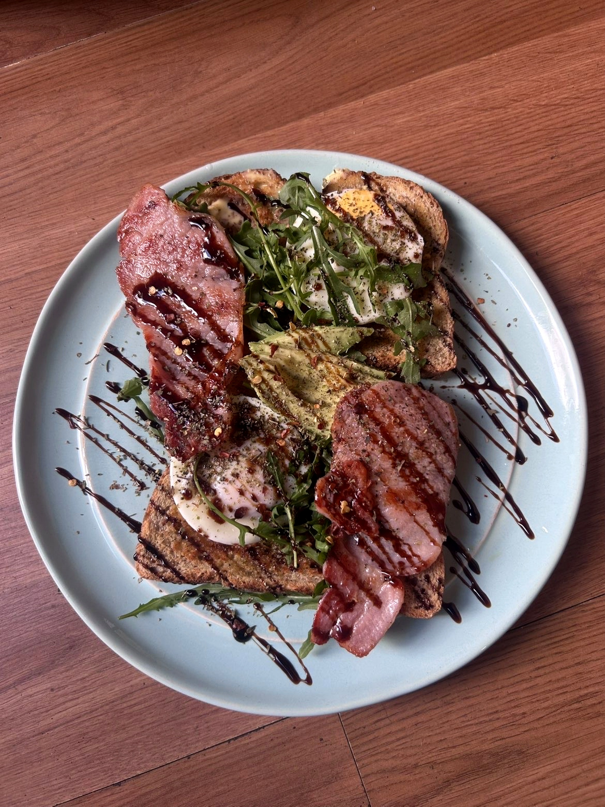 Cafe V76 bacon avocado toast with eggs, rocket and balsamic glaze